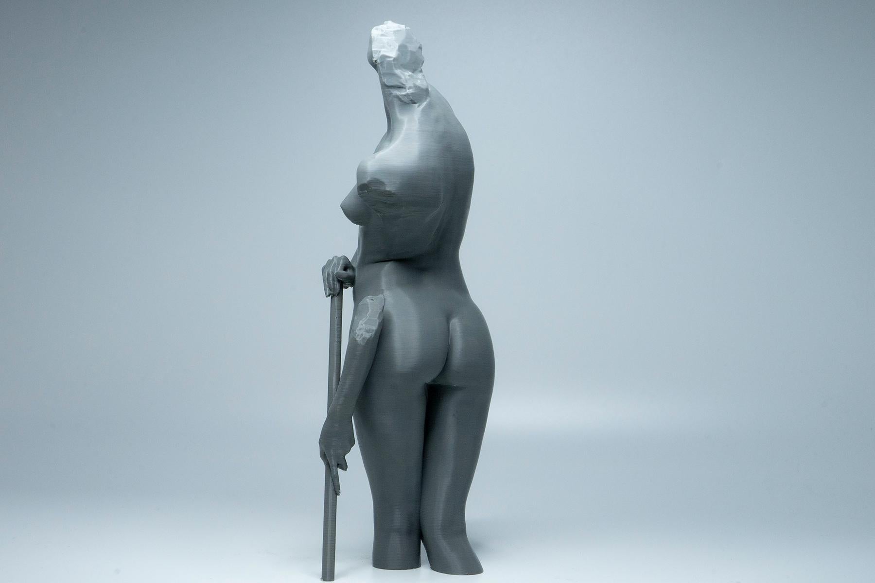 Female figure anatomy model holding prop. Artist reference sculpture for studying weight distribution and structural form.