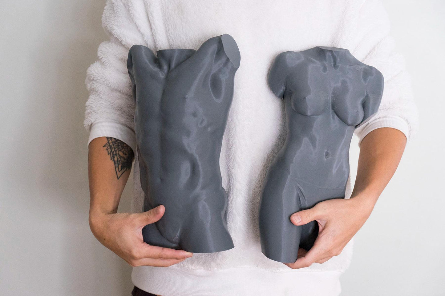 Male torso anatomy sculpture with raised arm for artists. Figure drawing reference model for studying ribcage stretch and muscular structure. holding sculpture