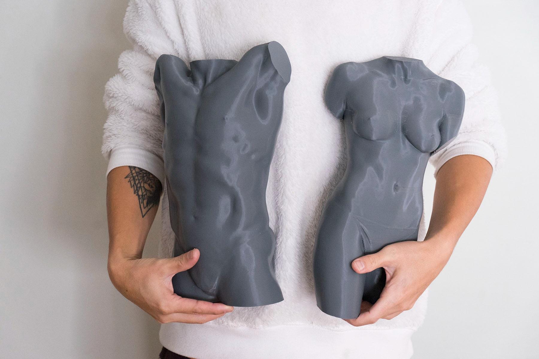 Male torso anatomy sculpture with raised arm for artists. Figure drawing reference model for studying ribcage stretch and muscular structure. holding sculpture