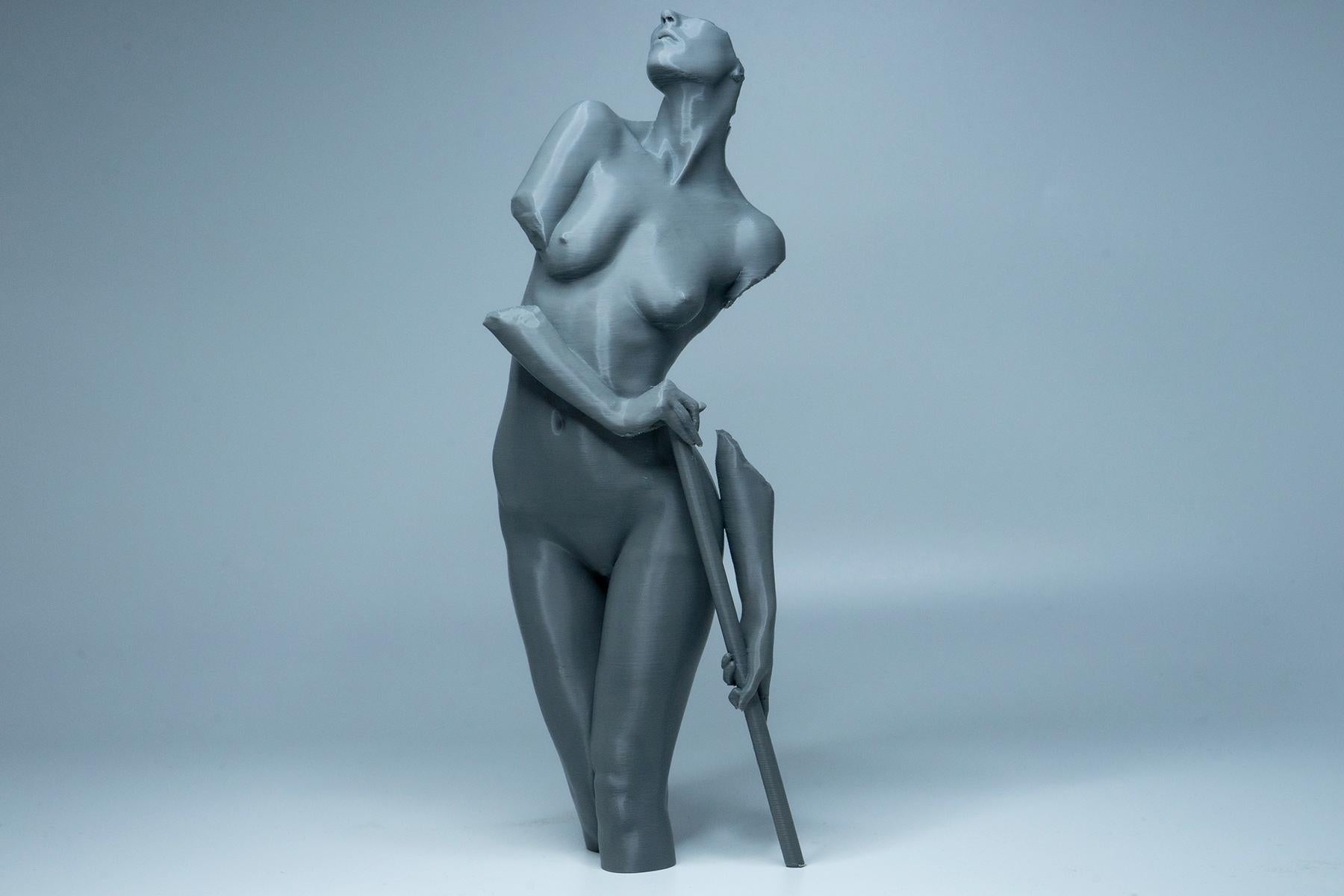 Female figure anatomy model holding prop. Artist reference sculpture for studying weight distribution and structural form.