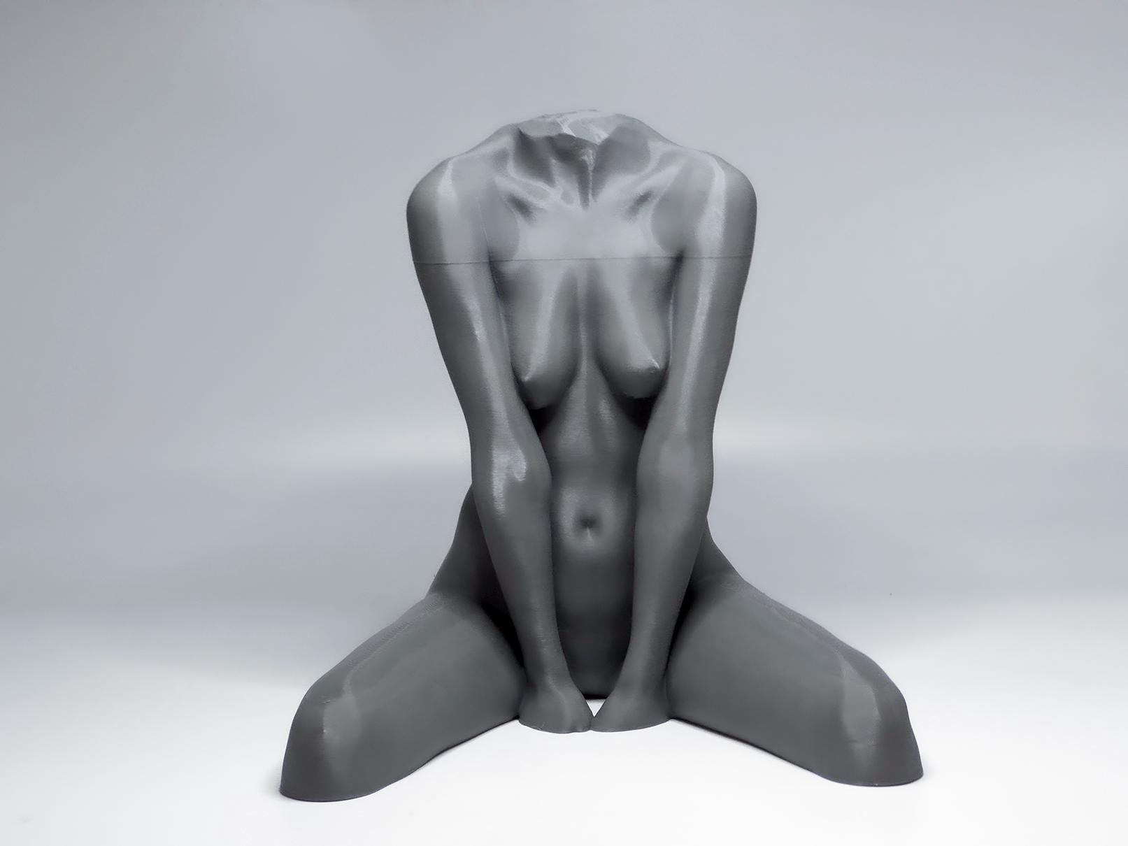 Seated female figure sculpture designed for artists studying anatomy, proportion, and grounded poses.